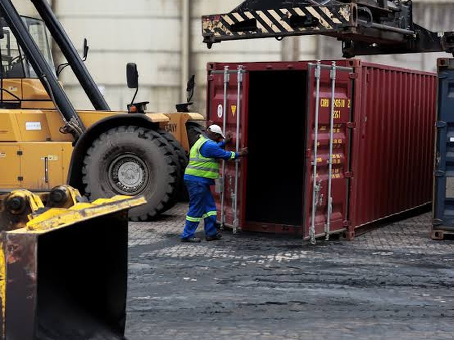 Cargo handling operation with a forklift moving a shipping container